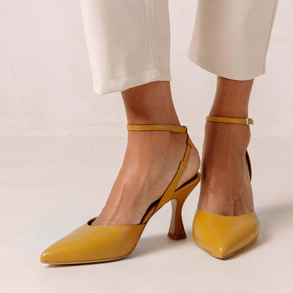 Alohas Cinderella marigold leather pumps on model wearing white cropped jeans