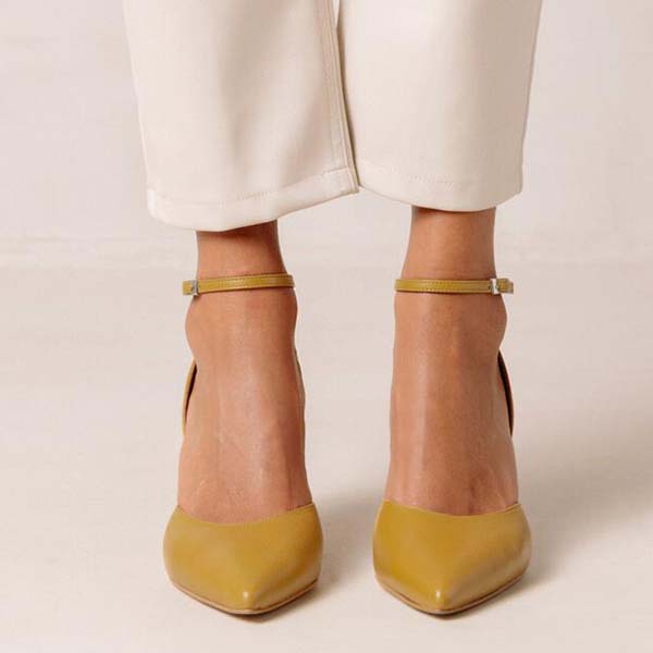 Alohas Cinderella marigold leather pumps on model wearing white cropped jeans