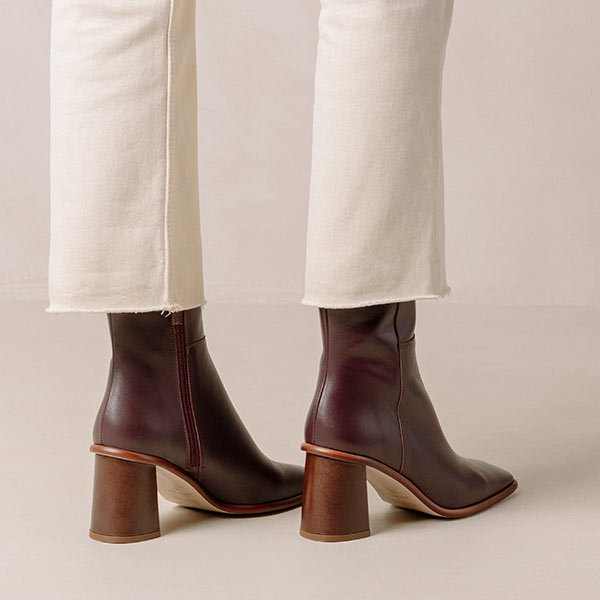 Alohas west vintage wine burgundy leather ankle boots on model wearing white cropped jeans