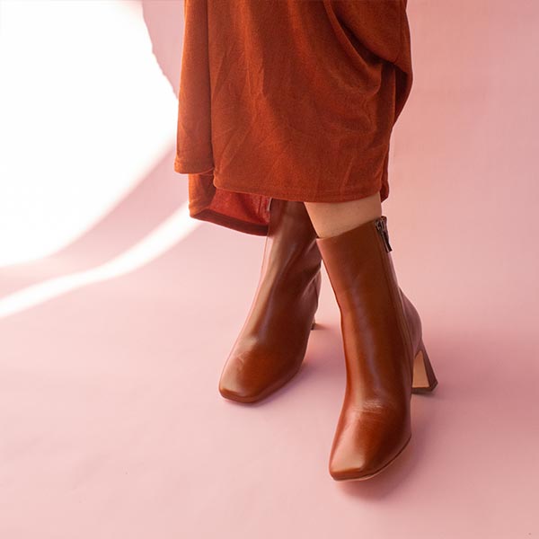 Mi/Mai Darcy ankle boot in brown leather on model with terracotta skirt