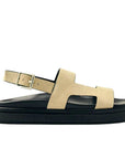 Beige sandal with black sole on a white background