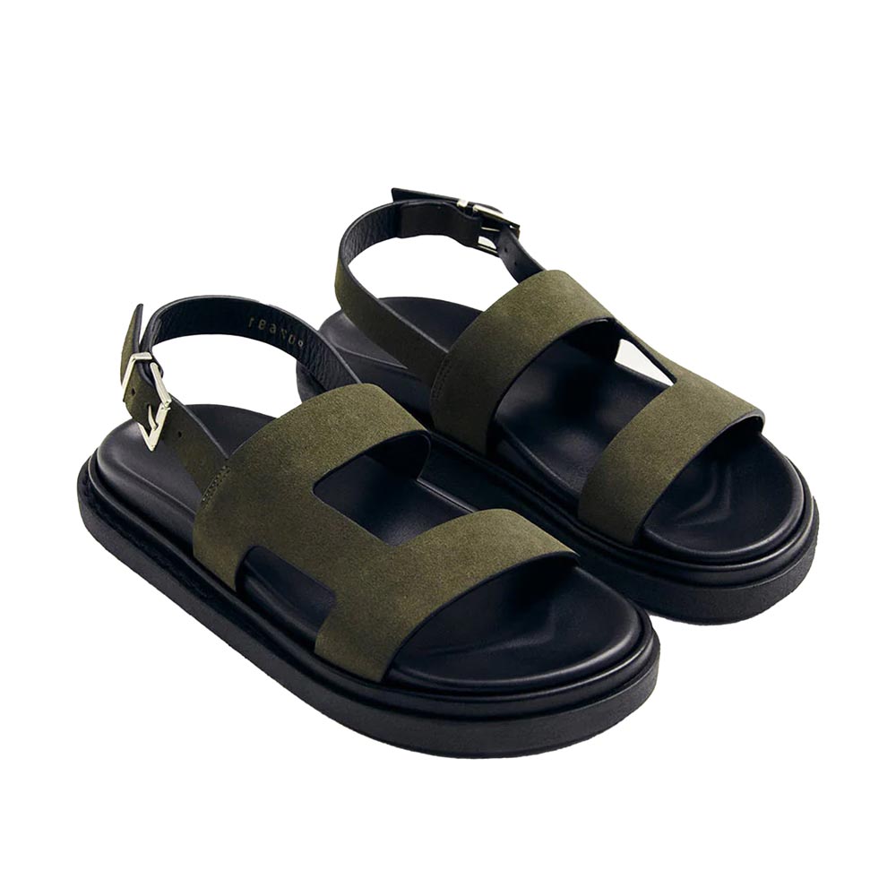 Pair of green sandals with black soles on a white background