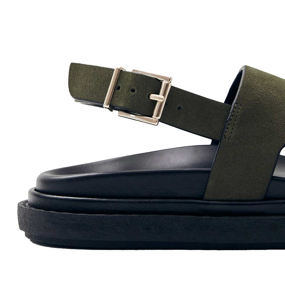 Green sandal with a buckle on a white background