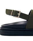 Green sandal with a buckle on a white background