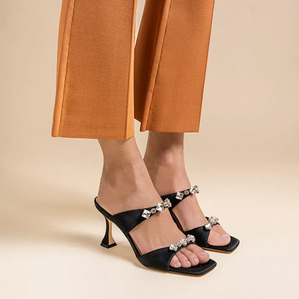 Mi/Mai Raina mules in black satin showing off silver crystal details and sculptural heel