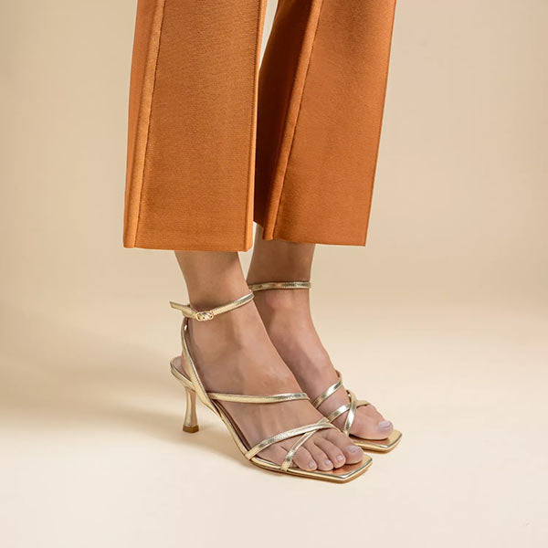 Mi/Mai Venice strappy sandal  with ankle strap in soft metallic gold leather styled with orange trousers 