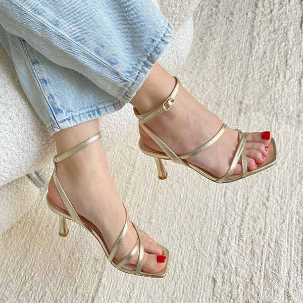 top view of Mi/Mai Venice strappy sandal  with ankle strap in soft metallic gold leather styled with light wash denim jeans