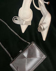 Silver metal hard shell clutch in art deco pattern with silver chain strap 