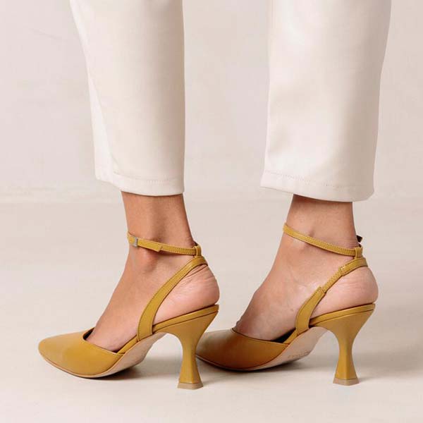 Alohas Cinderella marigold leather pumps on model wearing white cropped jeans