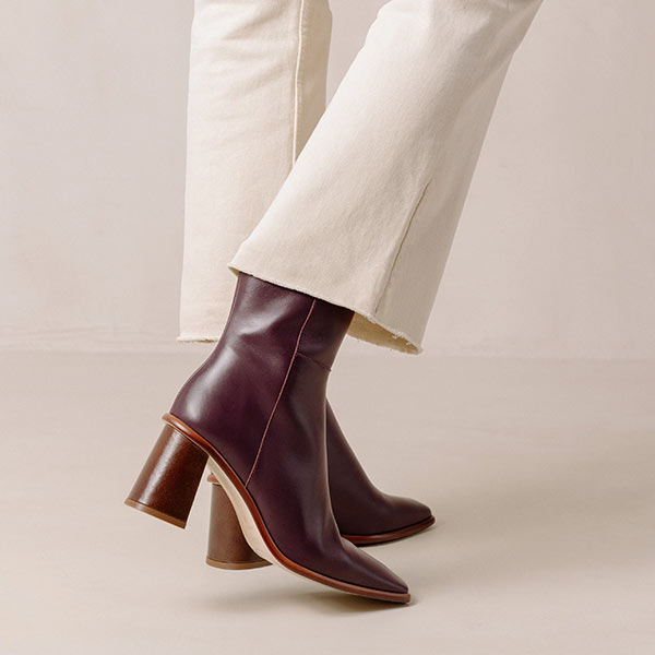 Alohas west vintage wine burgundy leather ankle boots on model wearing white cropped jeans