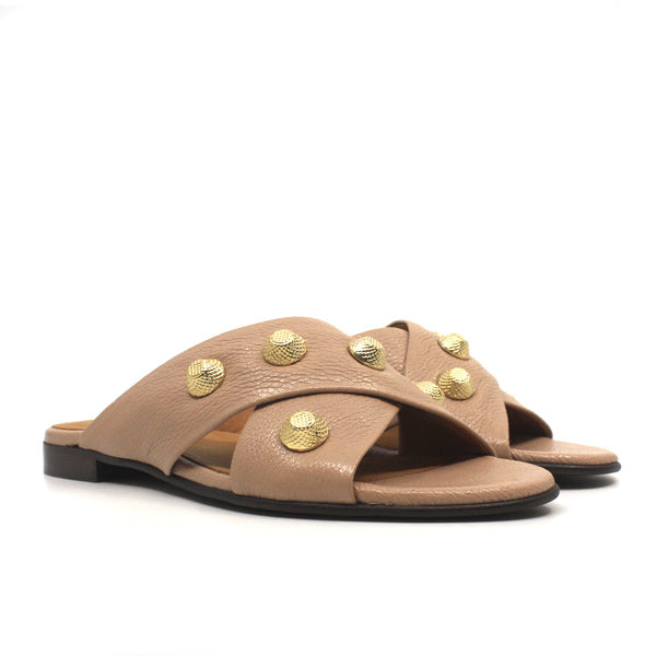 angle view pair of light pink textured leather Billi Bi flat crossover slide with gold stud detail