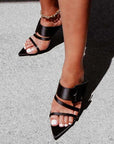 Kat Maconie Penitas black satin mule on model close up 1