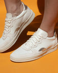 Maison Toufet Lisa sneaker in cream and metallic on model 