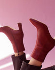 Mi/Mai Darcy mid heel ankle boot in red leather on model on pink background